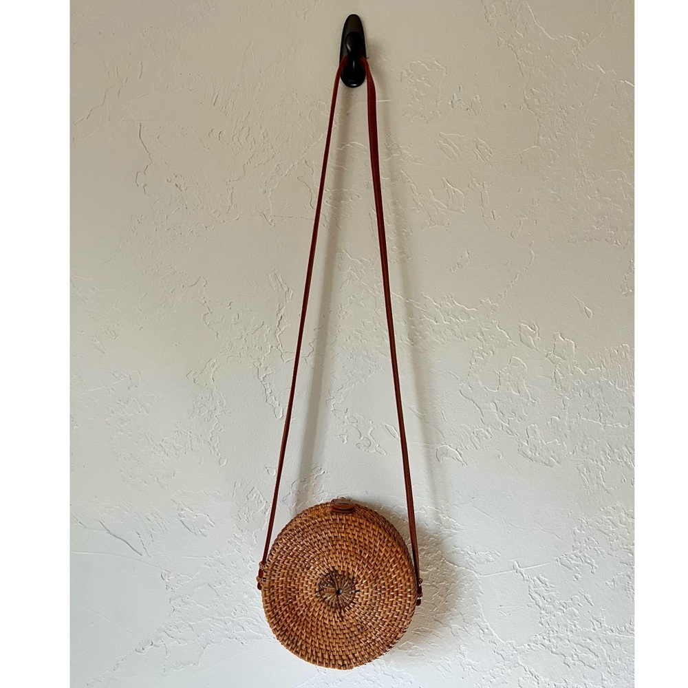 Woven rattan and leather round bag.
